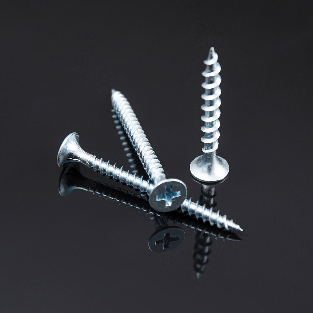 Close-up view of self-tapping screws driven into a sheet metal panel assembly